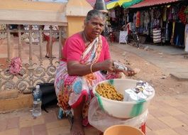 peanut seller, dark skin woman on street, india