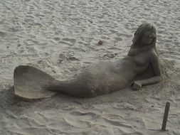mermaid figure in the sand