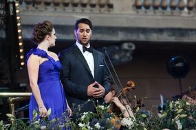 Louise Adler and Philip Rhodes sing on stage