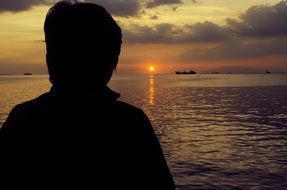 woman silhouette ocean sunset