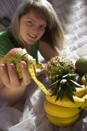 girl holds exotic fruit in hand