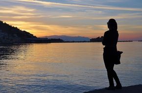 woman at sunrise near the water