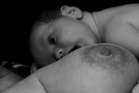 woman naked breasts with baby born