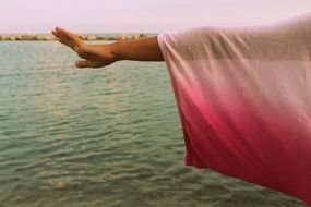 girl's hand over the water
