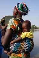 african woman carrying child at her black