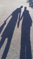 shadow of man and woman holding hands