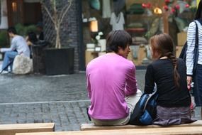 couple is sitting on a bench in Seoul, Korea