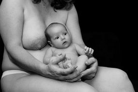 naked woman with newborn baby