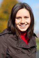 portrait of a smiling girl in autumn