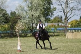 photo of the woman is riding on a horse