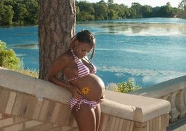 young pregnant woman in bikini