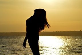 female silhouette at sunset