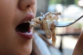 girl and fork with food