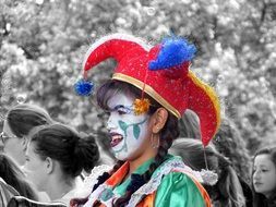 a girl in a clown costume at a festival