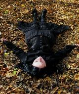 gothic girl lies on the grass