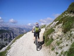 Woman is riding on the mountain bike in the Italy