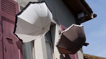 two umbrellas on the facade of the house