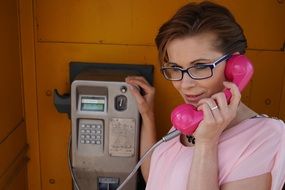 woman calling pay telephone