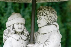 statues of girl and boy on the street