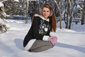 Woman is sitting in the snowy clipart