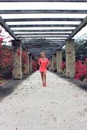 girl in a pink dress in the alley