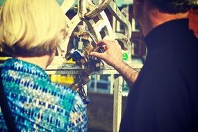 couple with love lock on ha'penny bridge, ireland, dublin