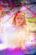 spring girl with sakura tree branches as a fantasy