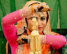 Indian girl with traditional jewelry decorations at the ceremony