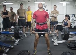 man with a heavy barbell in the gym