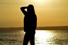 silhouette of a woman on a sea