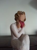 figurine of the woman with a heart