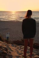 girl watching the sunset over the sea