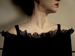 woman with red lips in a black lace dress