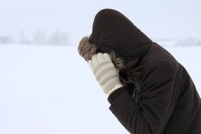 man in jacket during a blizzard