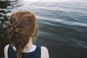 small girl looking at water