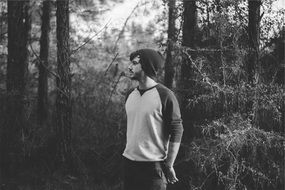 young guy in dark forest