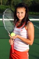 photo of a girl with a tennis racket and ball