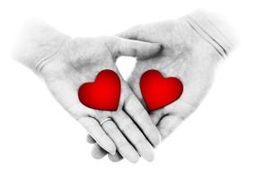 female and male hands with red hearts