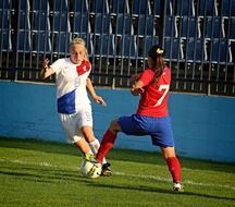 girls playing football on the field