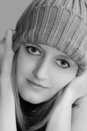 black and white photo of a girl in a knitted cap