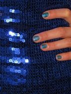hand on shiny blue dress