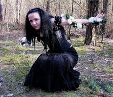 brunette woman model in forest, gothic sstyle