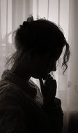 calm woman sitting by the window