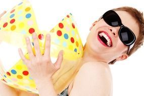 woman wearing sunglasses with a beach ball