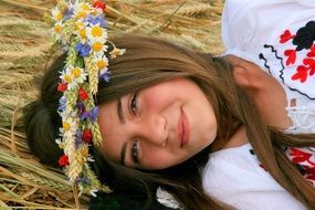 girl in a national dress and with a floral wreath on her head