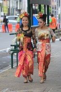 women are dressed in traditional clothes style