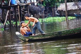 boys in a boat on Lake Tonle Sap, Cambodia