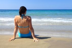 Female in blue bikini on the beach