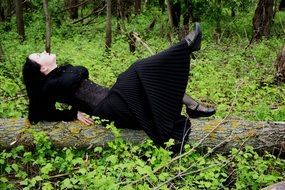 gothic girl in black dress in the autumn forest