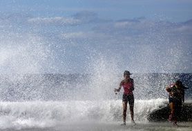 landscape of Woman running away from sea water sparkles